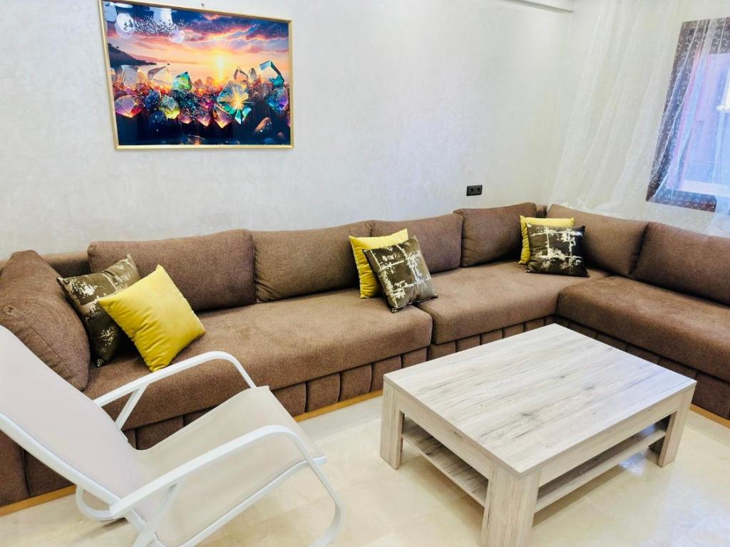 a living room with a couch and a coffee table at Soman Gueliz Center Apartment in Marrakech