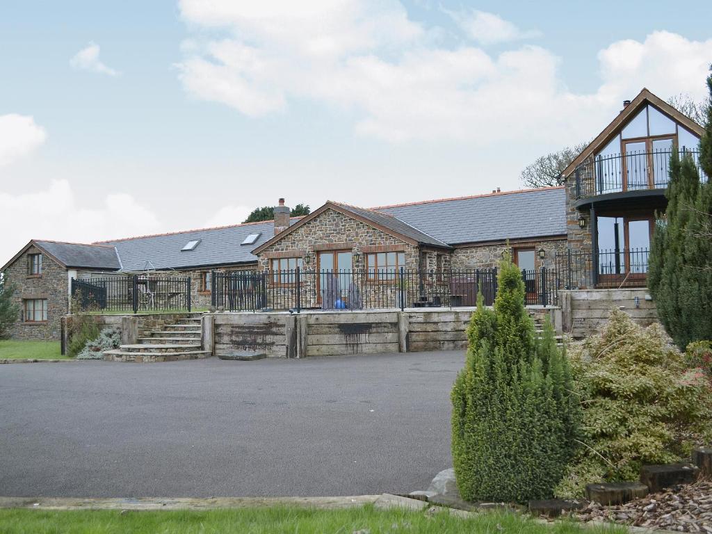 a house with a driveway in front of it at Ty Cerrig Farmhouse in Banc-y-felin