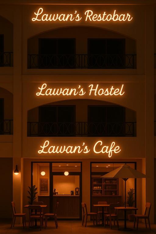 a restaurant with tables and chairs in front of a building at Lawans Hostel in Pattaya South