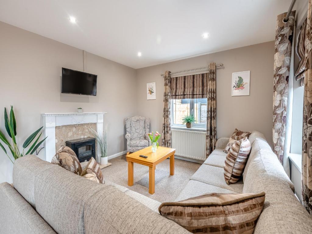 a living room with a couch and a fireplace at Cherry Blossom - Uk48837 in Skegness