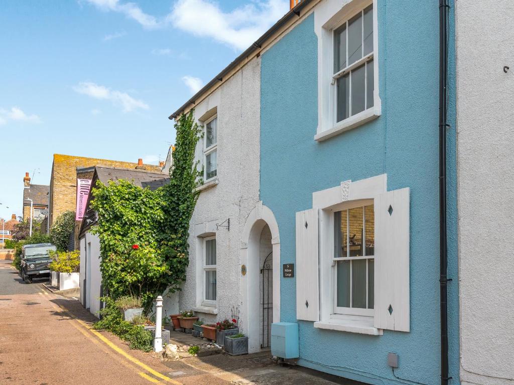 a blue and white house on the side of a street at Mcenroe Cottage in Broadstairs