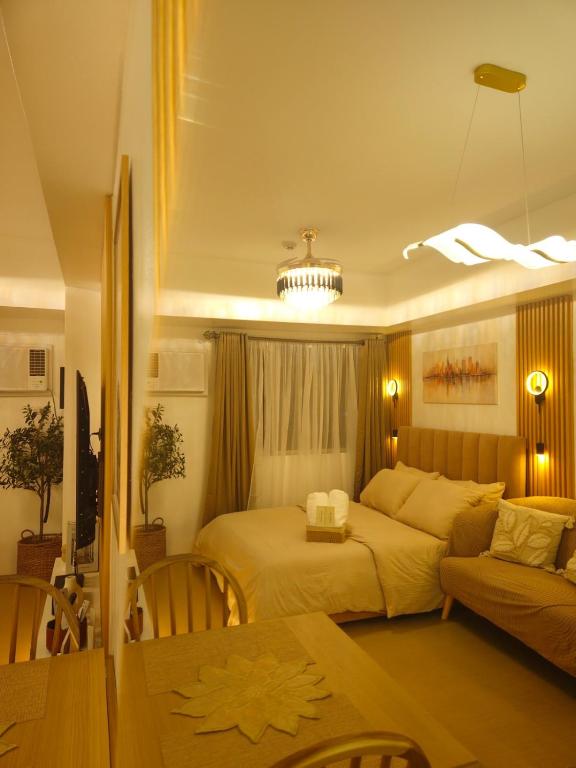 a bedroom with a bed and a couch at CDO Nest in Cagayan de Oro