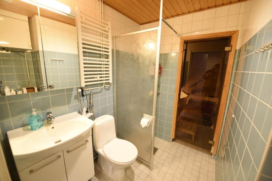 a bathroom with a toilet and a sink and a shower at City Center apartment at the Bus Station With balcony and sauna in Turku