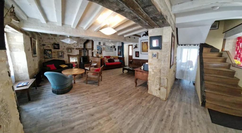 a large living room with a staircase and a living room at Welcome to SWEET HOME in Bélâbre