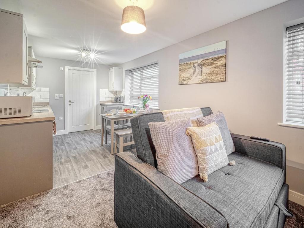 Una sala de estar con un sofá y una cocina. en Apartment 1 The Boardwalk - Uk31781, en Great Yarmouth