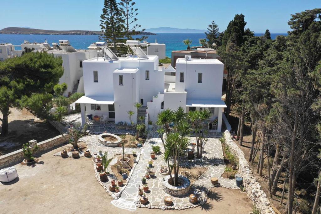 an aerial view of a white house with palm trees at kikis apartment a veranda dream in Drios