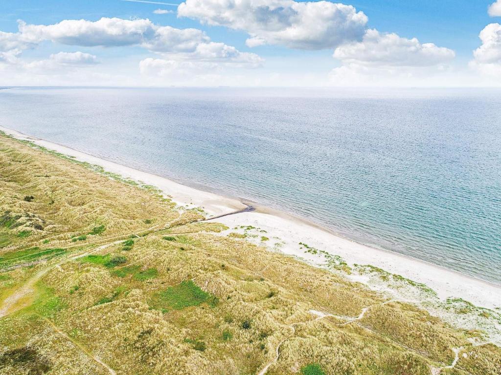 an aerial view of a beach with the ocean at 8 person holiday home in Ålbæk in Ålbæk
