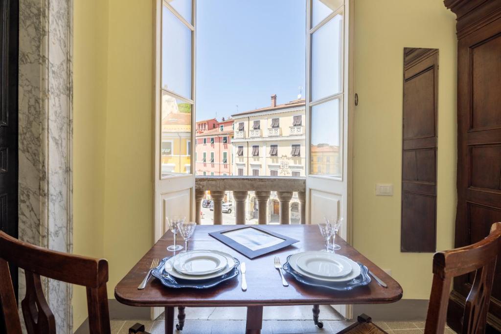 a dining room table with a view of the city at MATTEOTTI ROOMS in Sarzana