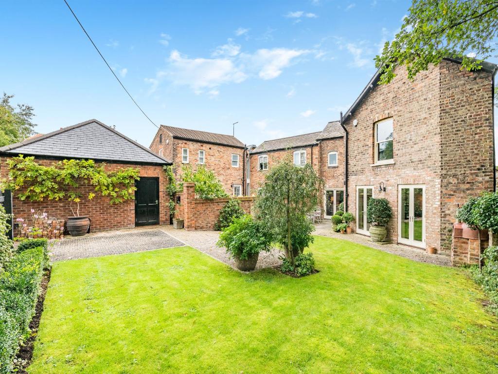 an exterior view of a brick house with a yard at The Lodge in York