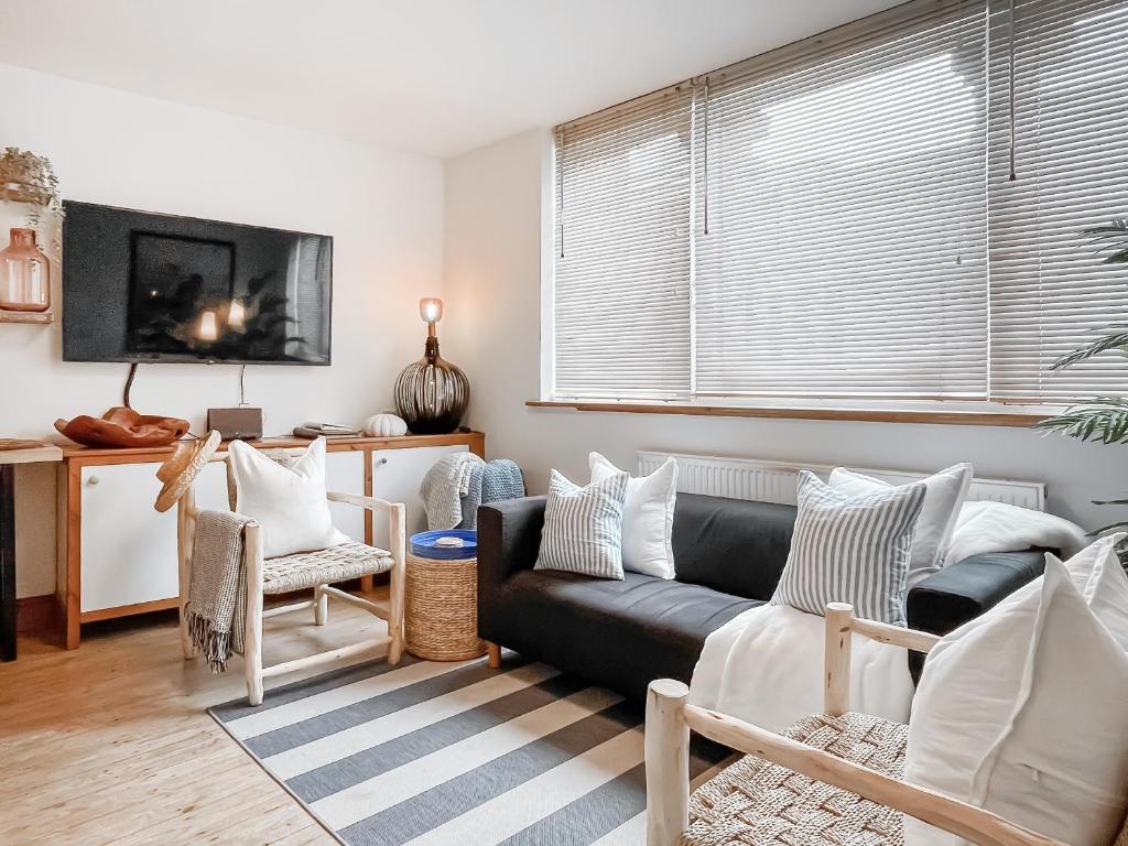 a living room with a couch and a tv at The Rise in Scarborough