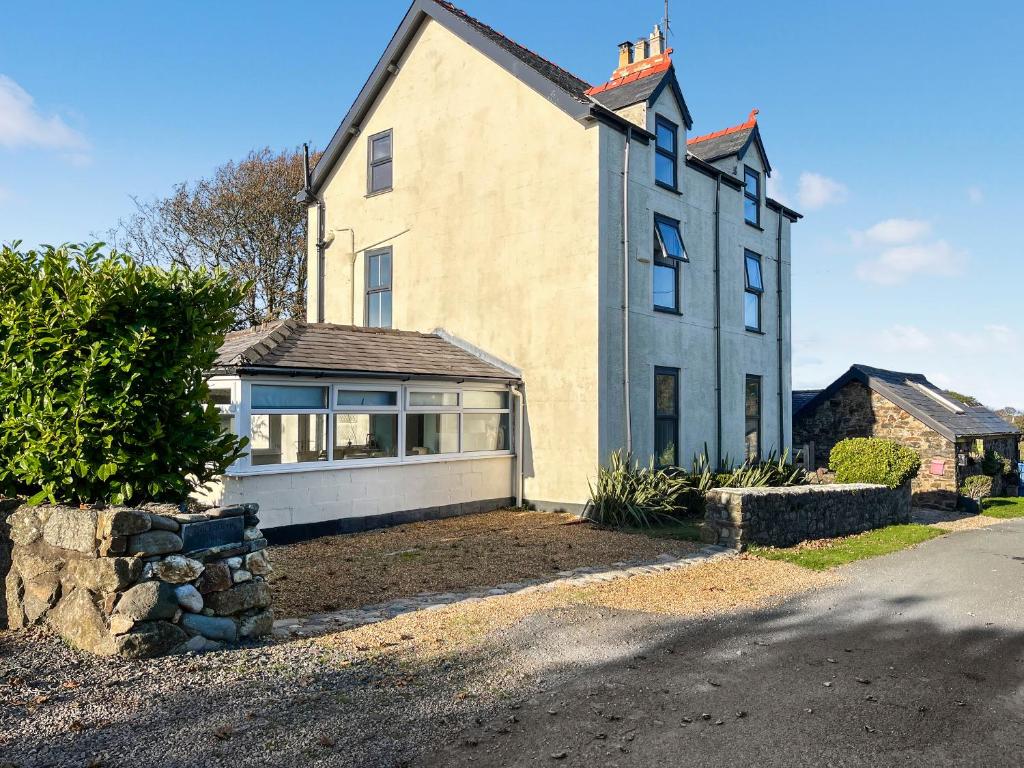 a large house with a large window on a street at Goleufryn in Abersoch