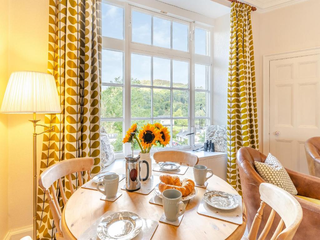 a dining room with a table and a window at Crag View in Ambleside