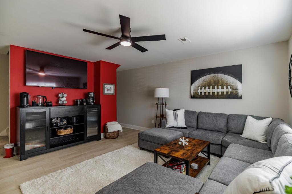 a living room with a couch and a flat screen tv at Classic City Quarters in Athens