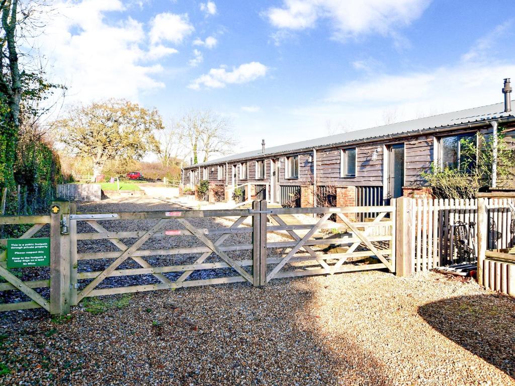 a wooden fence in front of a house at Rondo - Ukc3211 in Newbridge