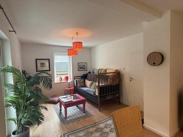 a living room with a couch and a table at Naturerlebnis direkt am Traumpfad in Andernach