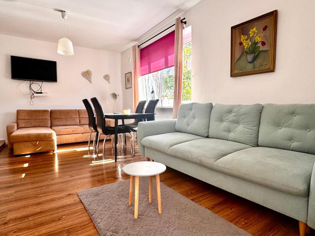 a living room with a couch and a table at Familly Apartament 3 in Międzyzdroje