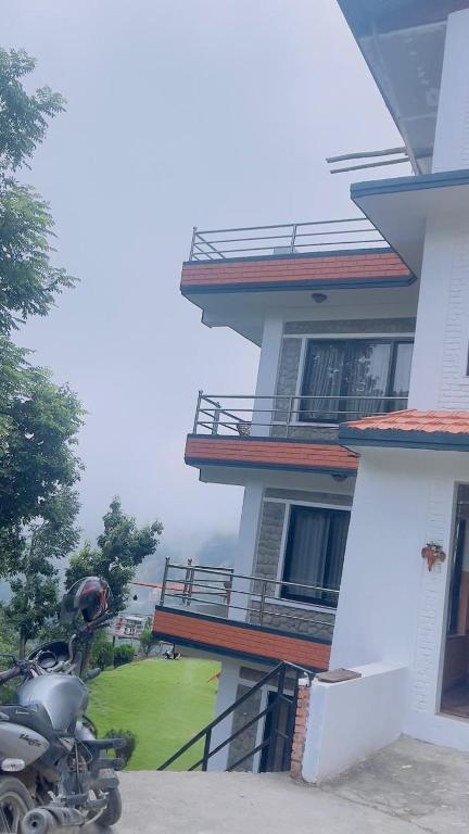 a motorcycle parked in front of a building at Hotel Indrawoti and Resort in Dhulikhel