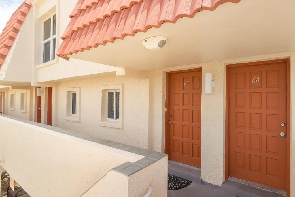 a house with two doors and a red roof at Pier Point South Oceanfront Townhouse Condo E-63 in Saint Augustine Beach