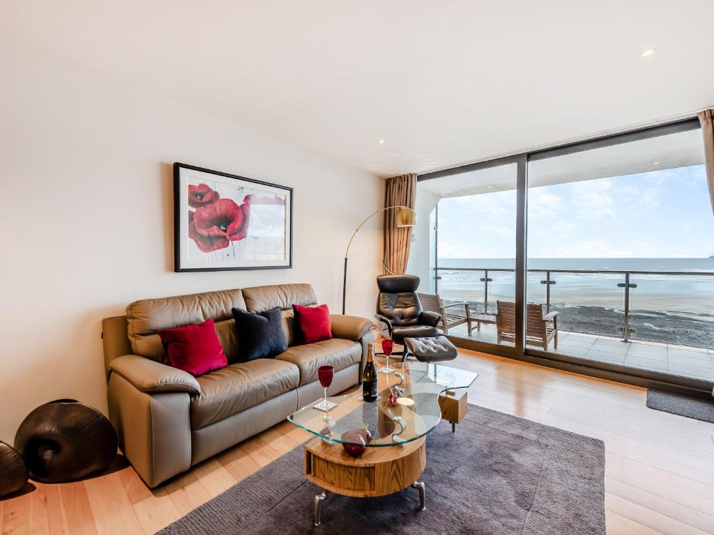 a living room with a couch and a table at Apartment 50 in Westward Ho