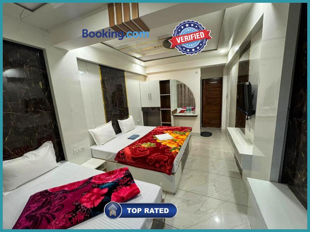 a hotel room with two beds and a tv at Hotel Mid-Town Nainital Near Mall Road Free Wifi & Room ServiceAvailable - Luxury Collection of Hotels with Spacious Room - Excellent Customer Service Awarded in Nainital