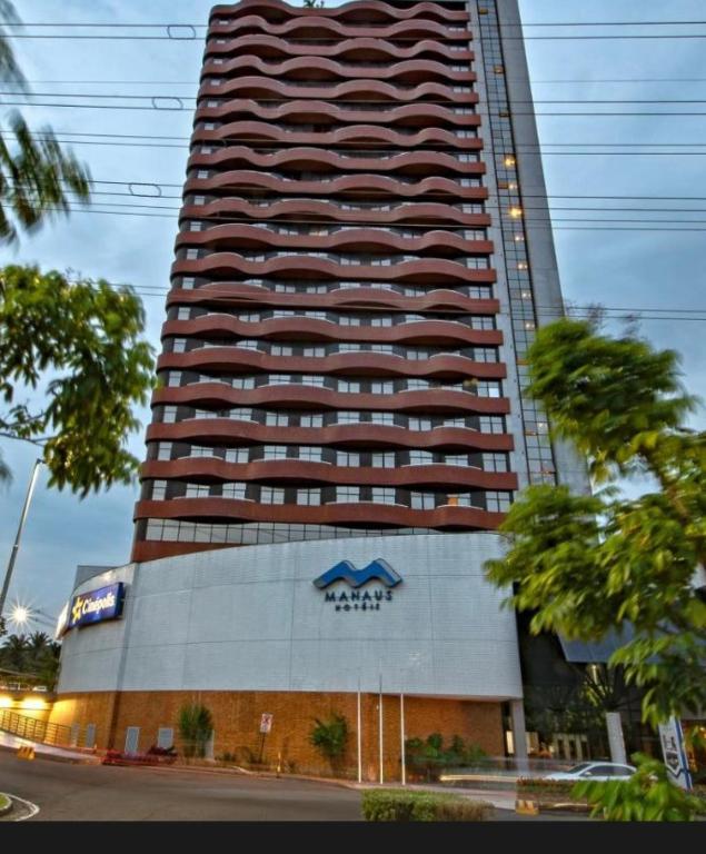 a tall building with a sign in front of it at Manaus Hotéis Millenium - Flat 804 in Manaus