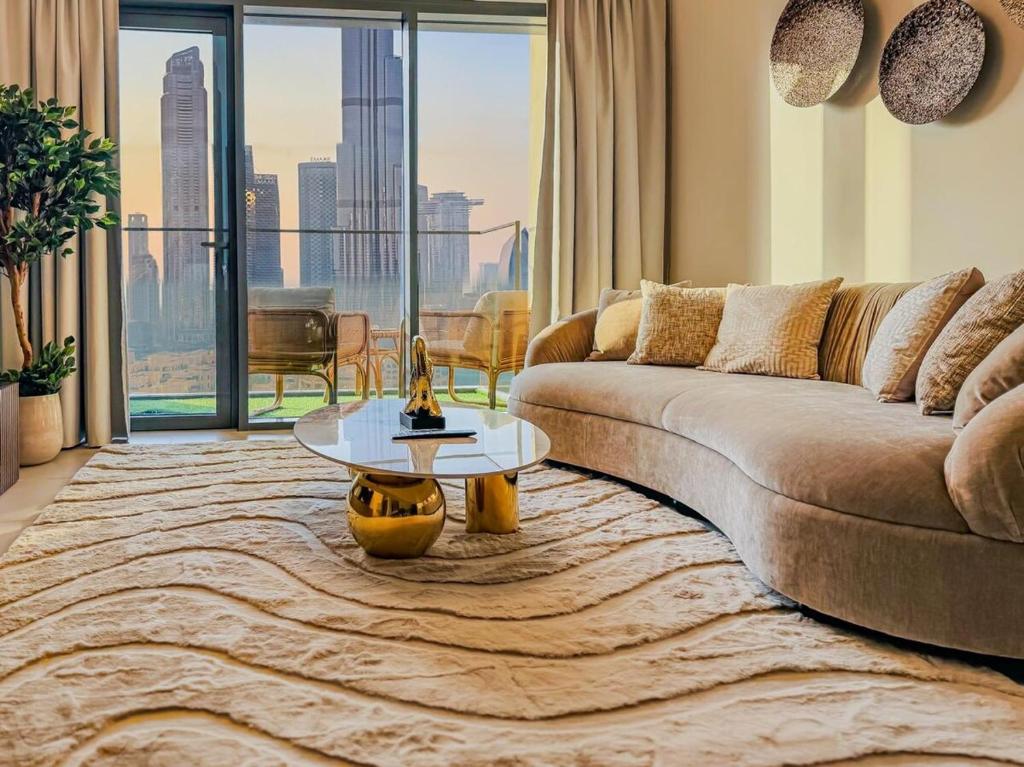 a living room with a couch and a table at Stunning Burj Khalifa View! Steps to Dubai Mall in Dubai