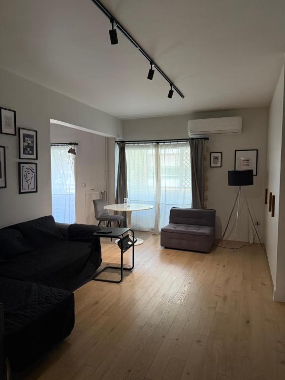 a living room with a couch and a table at 2 Bedroom 2 Bath Modern Apartment in Athens