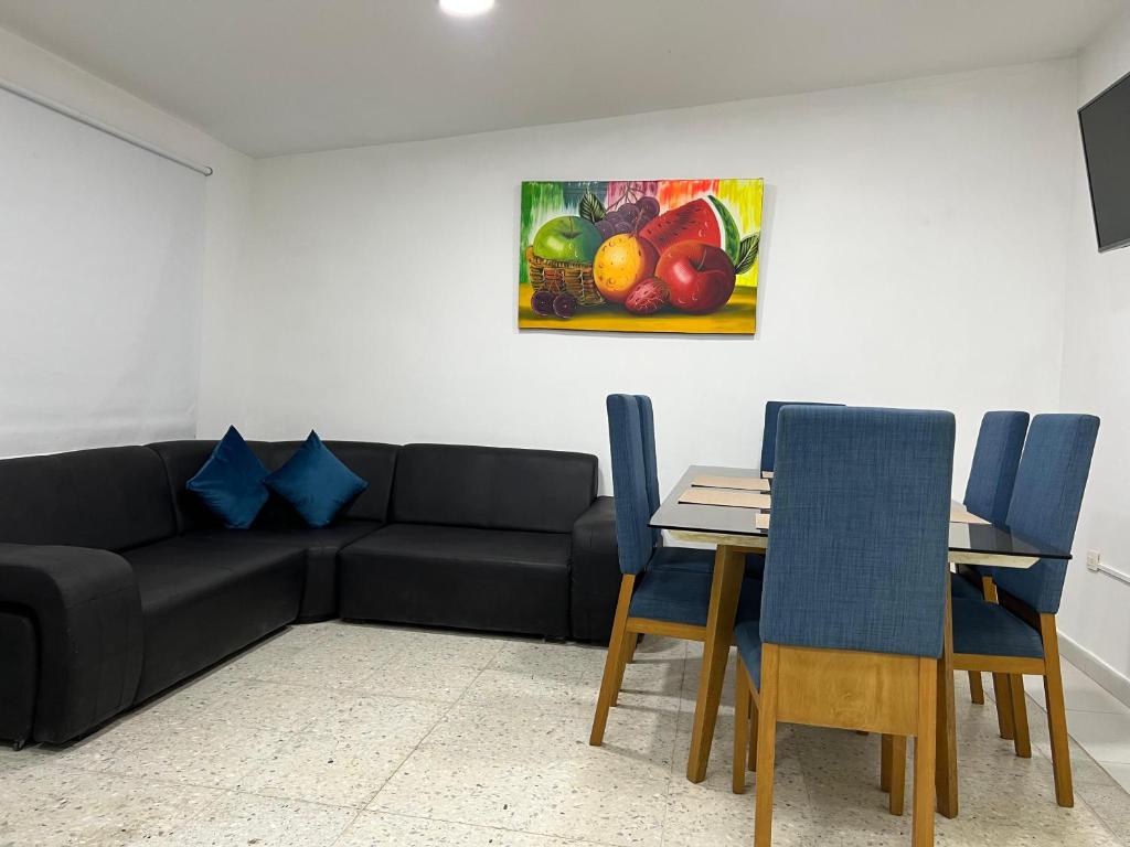 a living room with a couch and a table with chairs at Family house colonial-style in Cartagena de Indias