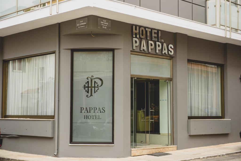 a hotel papas hotel sign on the side of a building at Hotel Pappas in Kiáton