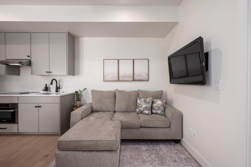 a living room with a couch and a kitchen at Luxurious Gem Near Zion & Sand Hollow in Hurricane