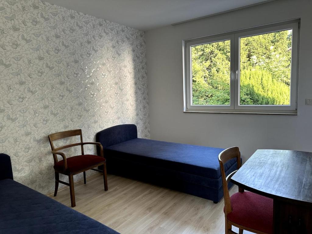 a room with a bed and a table and a window at Residenz Elegance in Bochum
