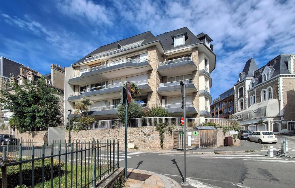 a tall building with a fence in front of it at Gorgeous Apartment In Dinard With House Sea View in Dinard