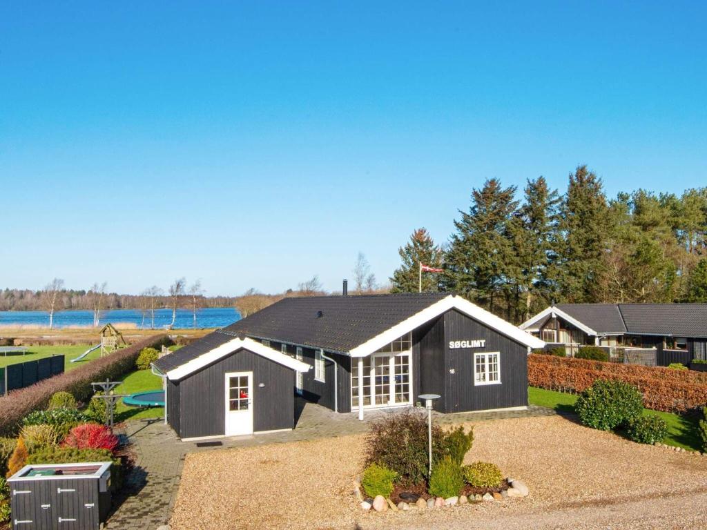 a large black and white house with a yard at 5 star holiday home in Ansager in Ansager