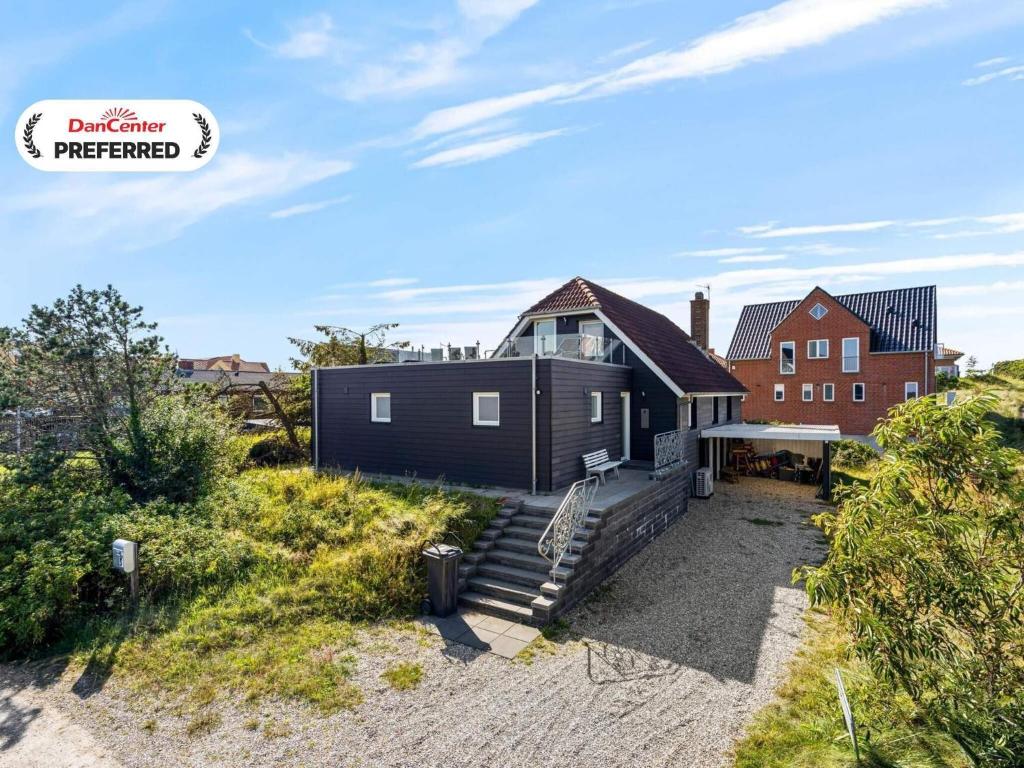 an exterior view of a house with a staircase at 4 star holiday home in Nørre Nebel in Nørre Nebel