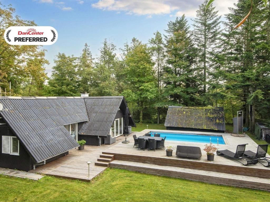 a backyard with a pool and a house at 6 person holiday home in Hemmet-By Traum in Hemmet
