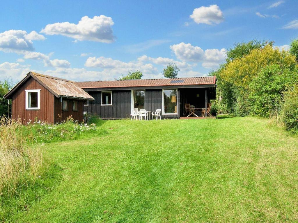 a house with a large yard in front of it at 6 person holiday home in Fårevejle-By Traum in Fårevejle