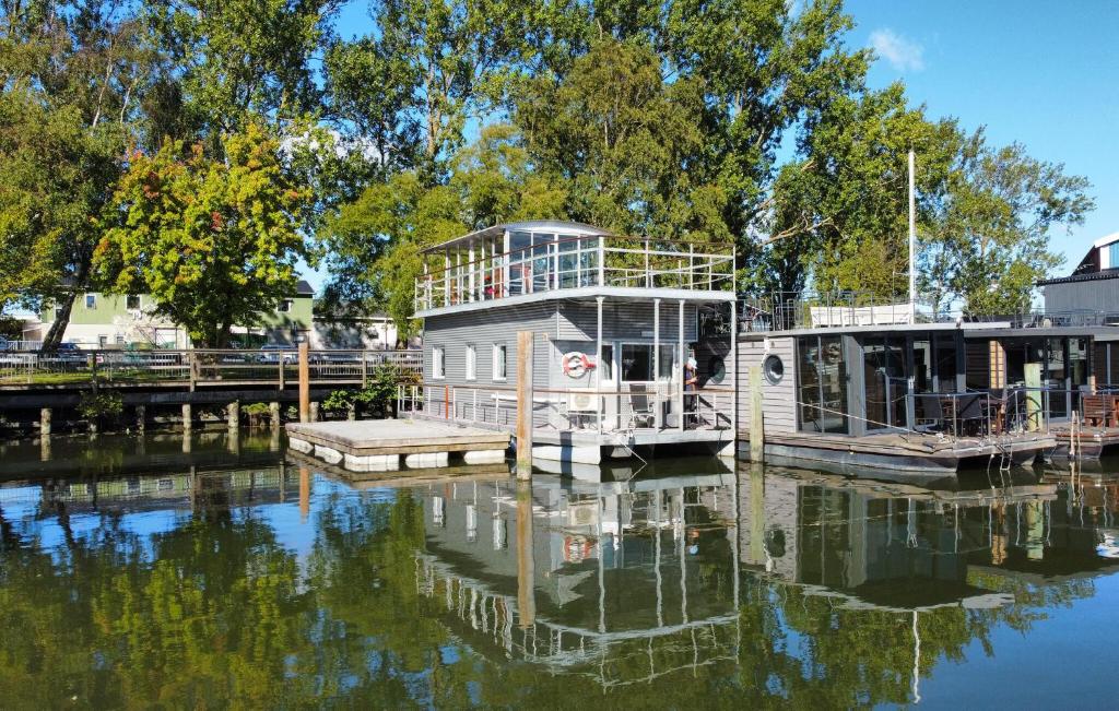 a house boat docked at a dock on the water at Nice Ship In Göteborg With Sauna in Gothenburg