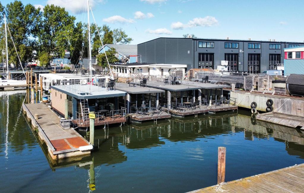 a marina with boats in the water next to a building at Stunning Ship In Göteborg With Sauna in Gothenburg