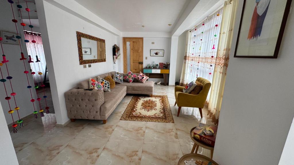 a living room with a couch and two chairs at Valle Sagrado in Coya