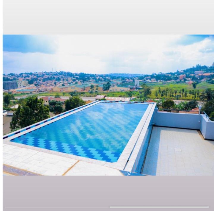a large swimming pool on top of a building at Mera Homes in Kampala