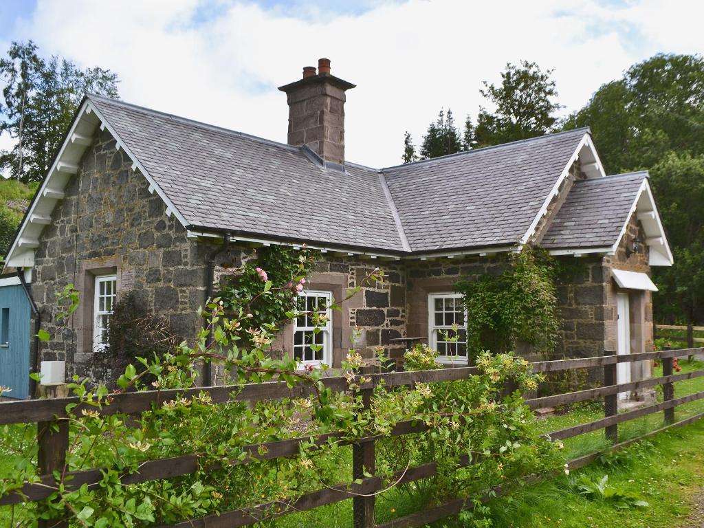 an old stone house with a fence at Westerton Lodge - Srrh in Crieff