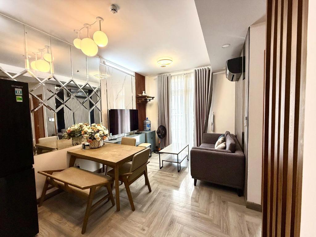 a living room with a table and a dining room at Sun House in Kinh Dinh