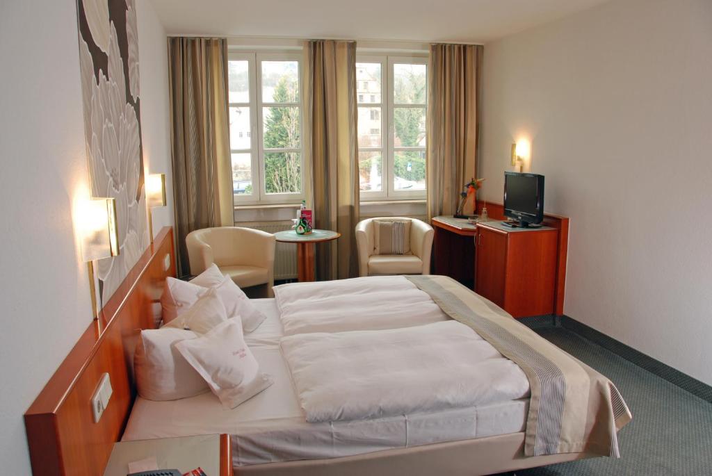 Postelja oz. postelje v sobi nastanitve Hotel Müller Café & Wein - Mondholzhotel