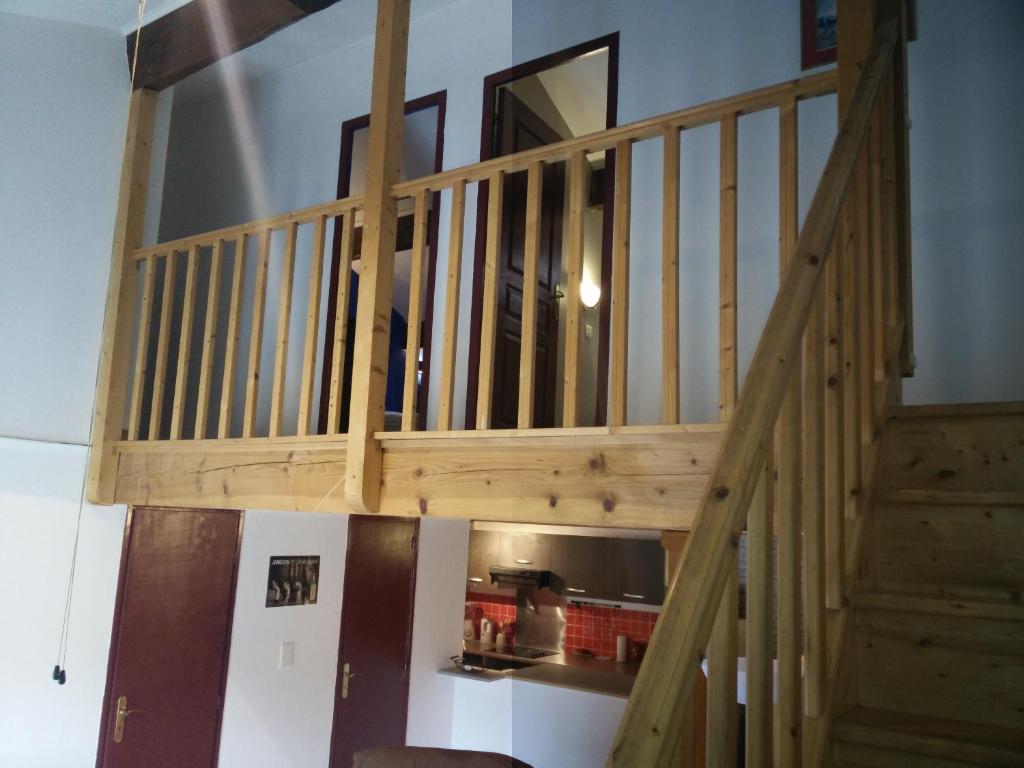 a wooden staircase in a room with at Appartement Anatole France in Saint-Gilles