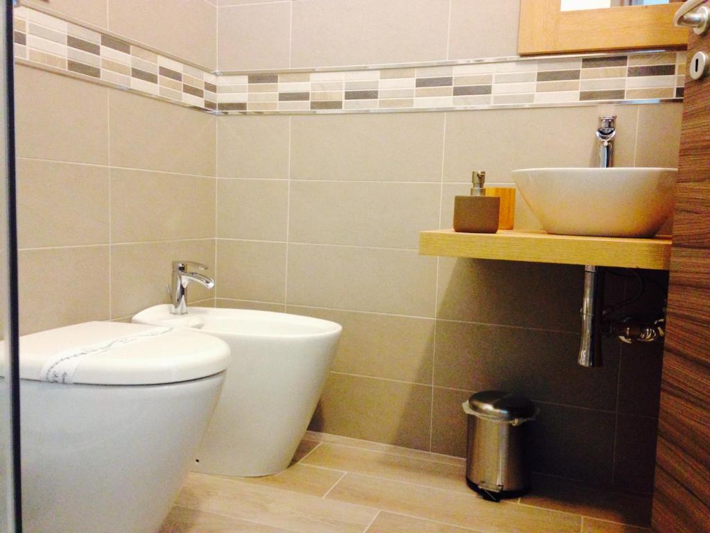 a bathroom with a toilet and a sink at Sweet Dreams in San Vito lo Capo