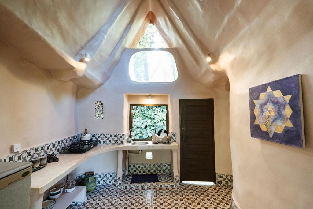 乌布Sacred Mandala retreat center Ubud的厨房设有大窗户 和瓷砖地板。