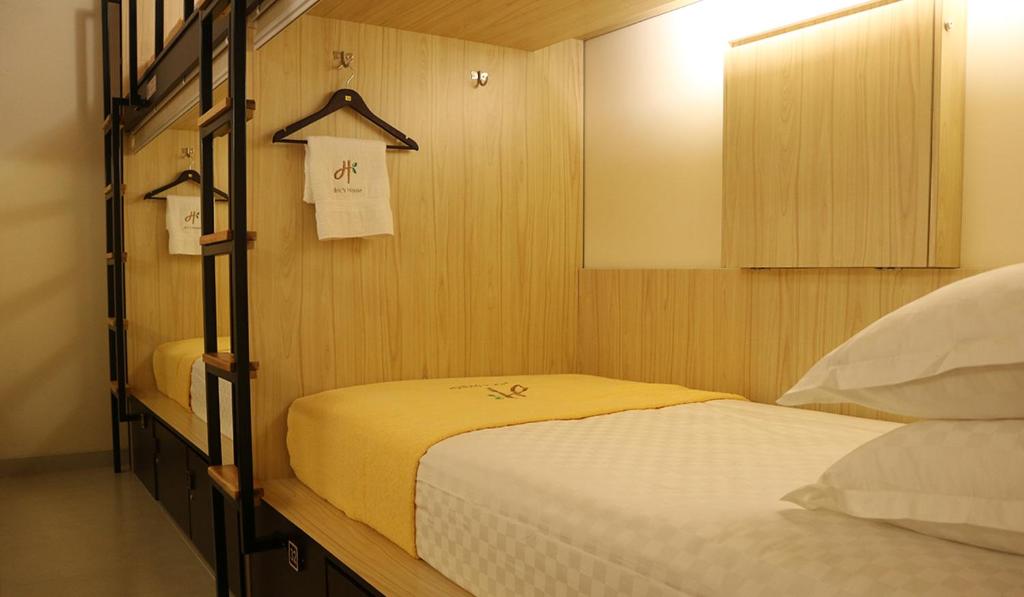 a bedroom with two beds and a mirror at dric's House in Tanjungpandan