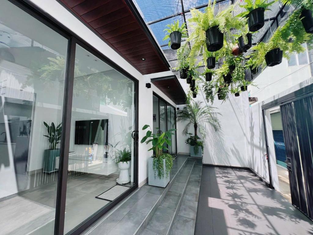 an internal courtyard of a house with potted plants at Cozy Boutique in Buon Ma Thuot