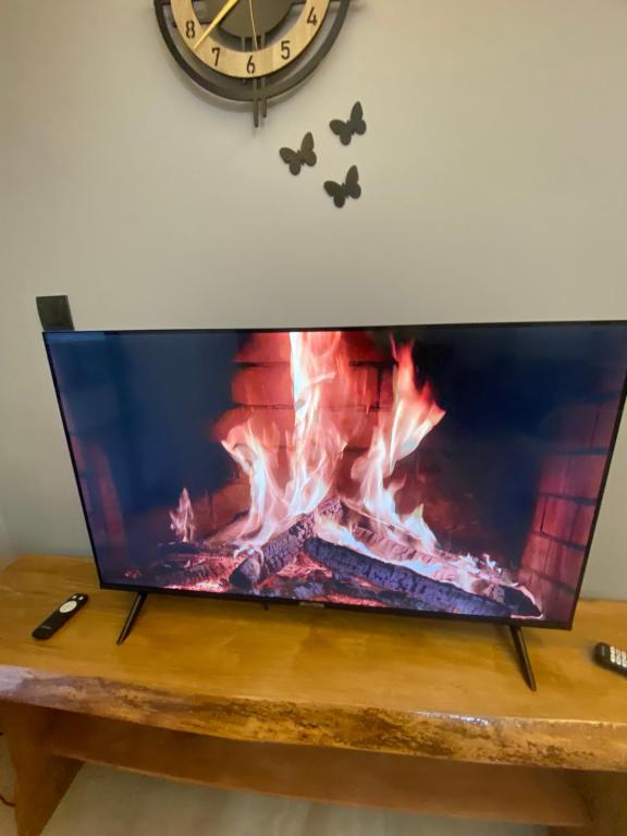 a flat screen tv sitting on a table with a fireplace at Merthous 19 in Atakum