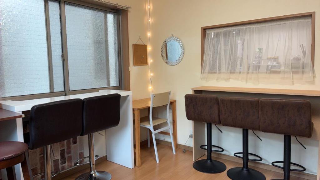 a kitchen with a bar with chairs and a table at Higashikurume station in Niiza City in Katayama